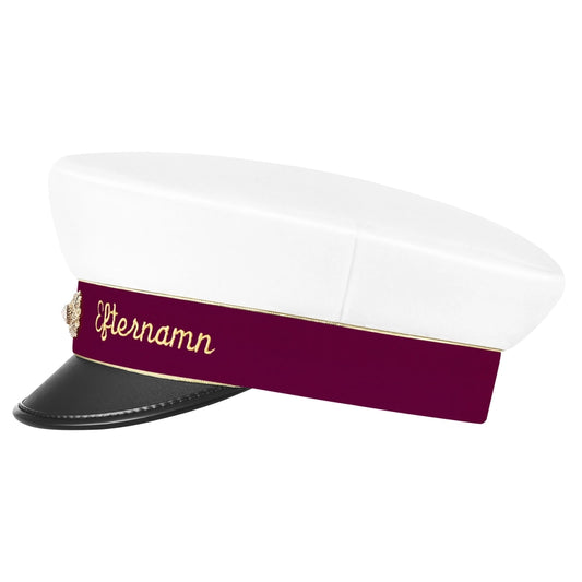Studentmössa med vinrött namnband, silverkant och guldkokard. Kan anpassas med namn brodyr. Se ifrån sidan. Levereras i en elegant presentförpackning med en silkeslen påse.